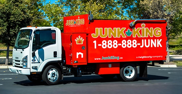 Red Junk King branded dump truck.
