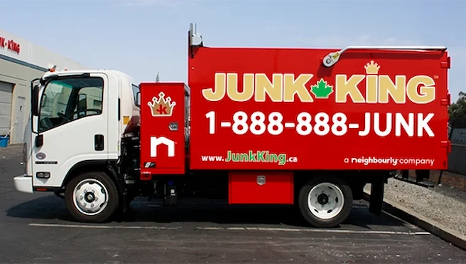 Junk King truck with phone number and Neighbourly branding displayed on the side.