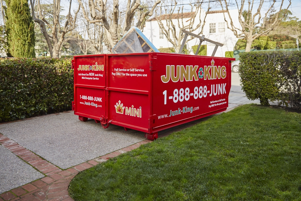 Junk King dumpster rental placed outside a home renovation project in Ashbury Heights