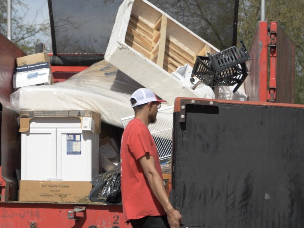 Junk King team removing an old mattress and bed frame in Pescadero, CA