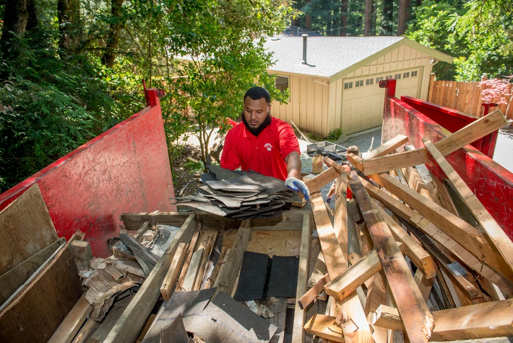 Junk King crew collecting yard waste from a home in Ashbury Heights