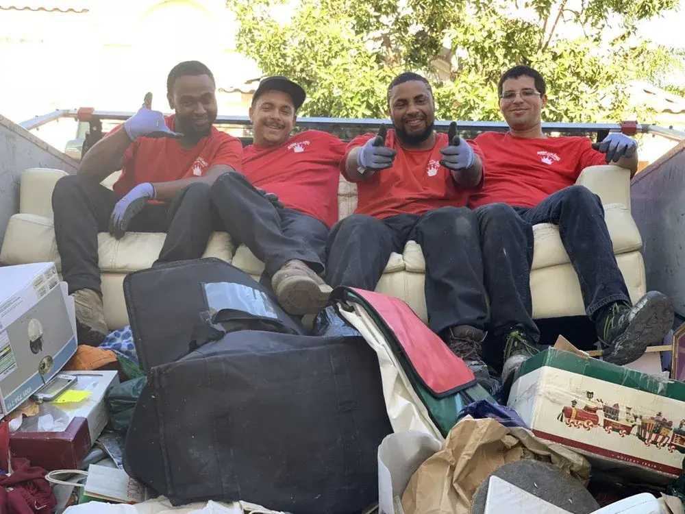 Junk King crew performing a full cleanout service at a San Carlos property
